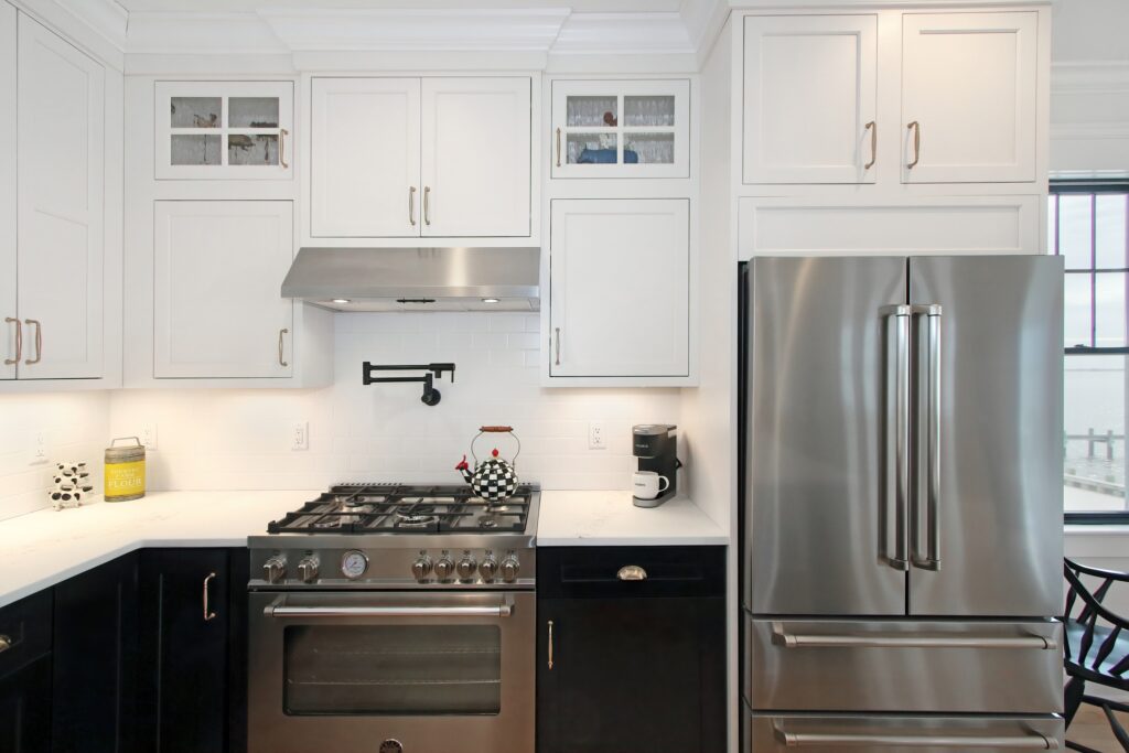 Custom kitchen cabinets with black and white combination, chrome appliances incorporated 