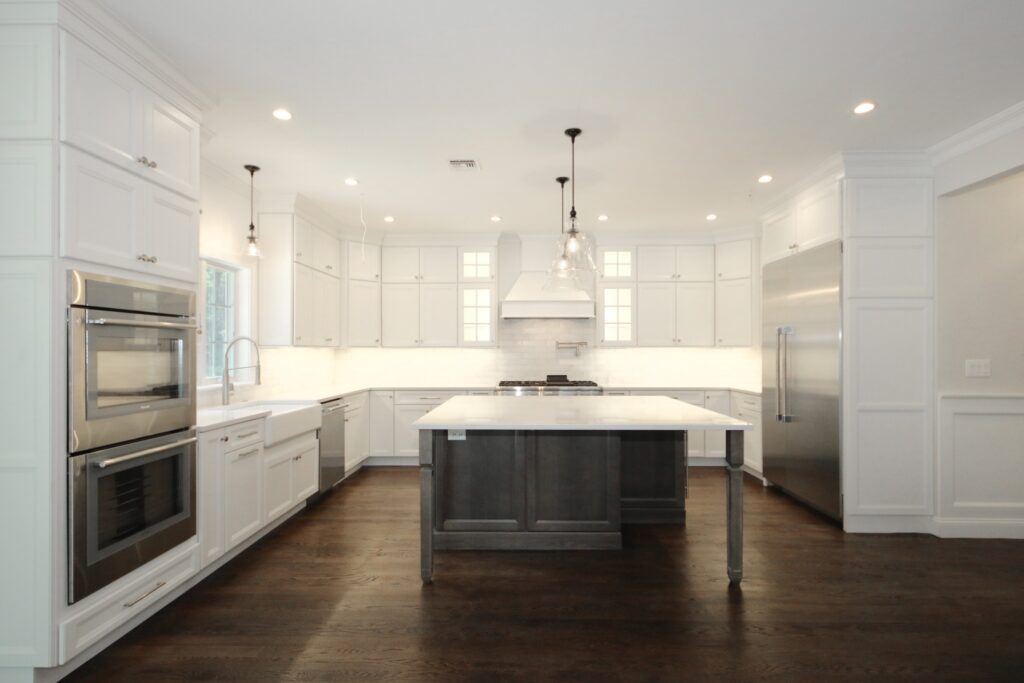White Custom kitchen cabinets with floating island and wall oven