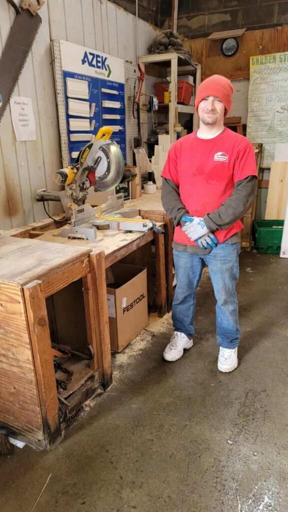 Builders’ General's employee standing by a workstation at Builders’ General Little Silver location